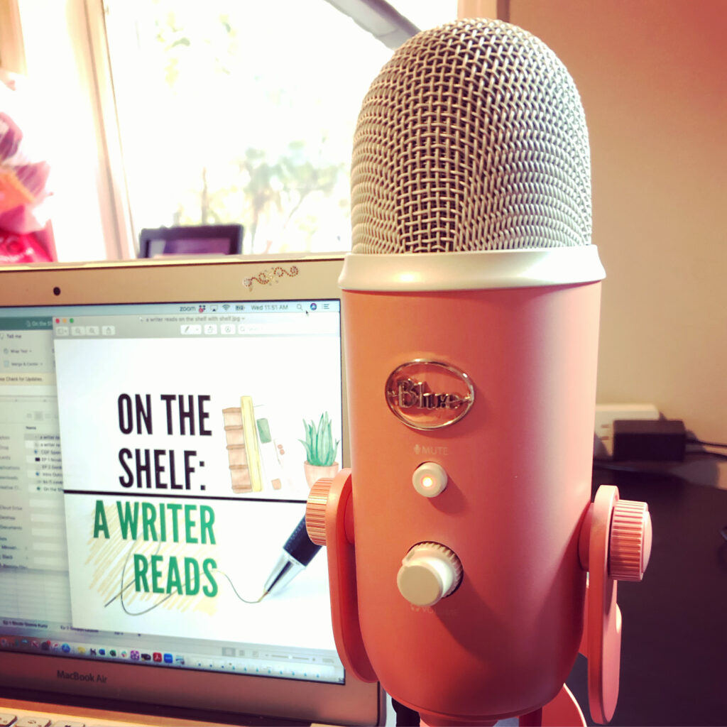 photo of a pink microphone with the logo "blue" and in the background, a computer with a graphic for the On the shelf podcast